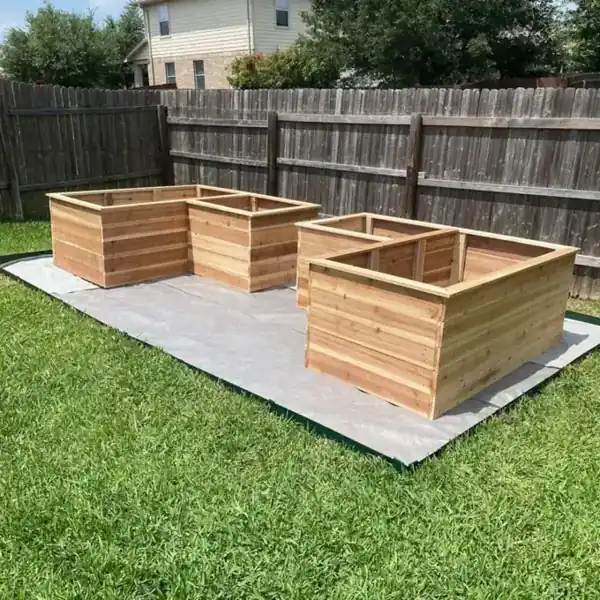 Matching raised garden beds photographed together in a backyard